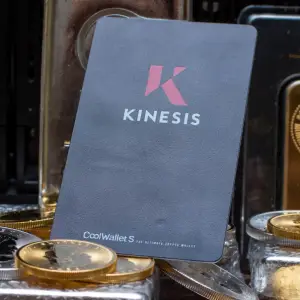 Kinesis card on gold coins and bars